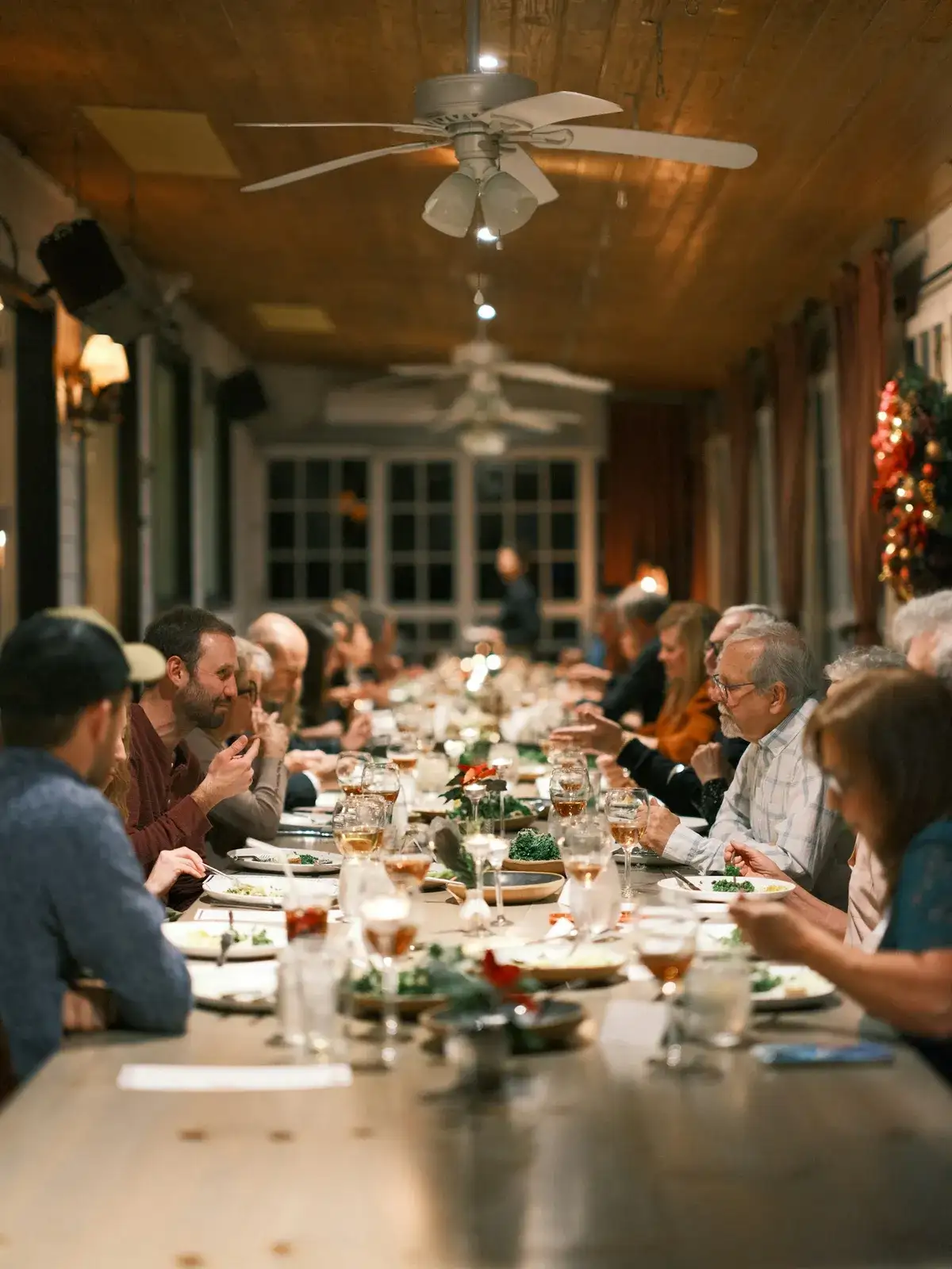 Guests sharing a meal at a long table during a community dinner