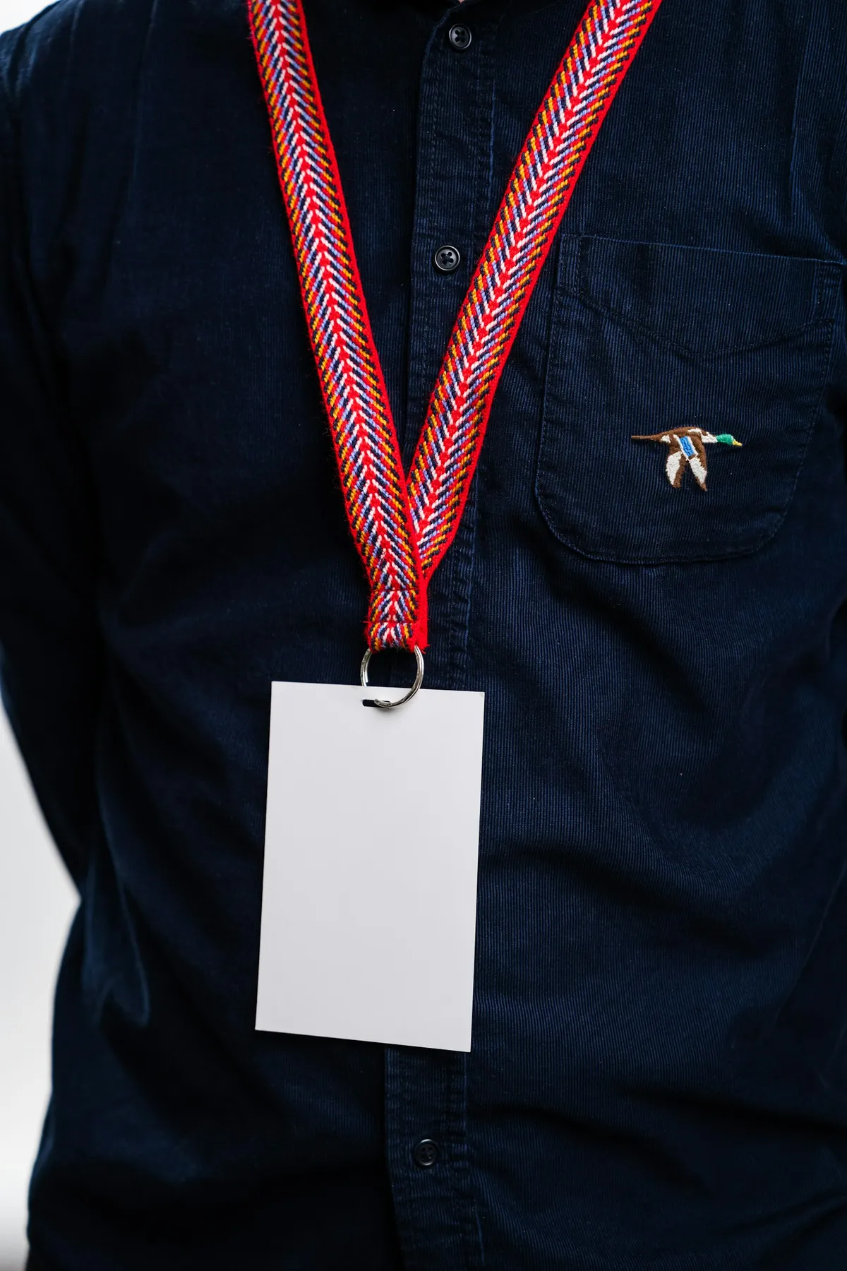 A volunteer wearing a lanyard with a blank name badge