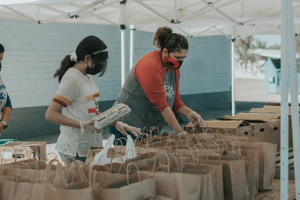 Volunteers working together at a community event table