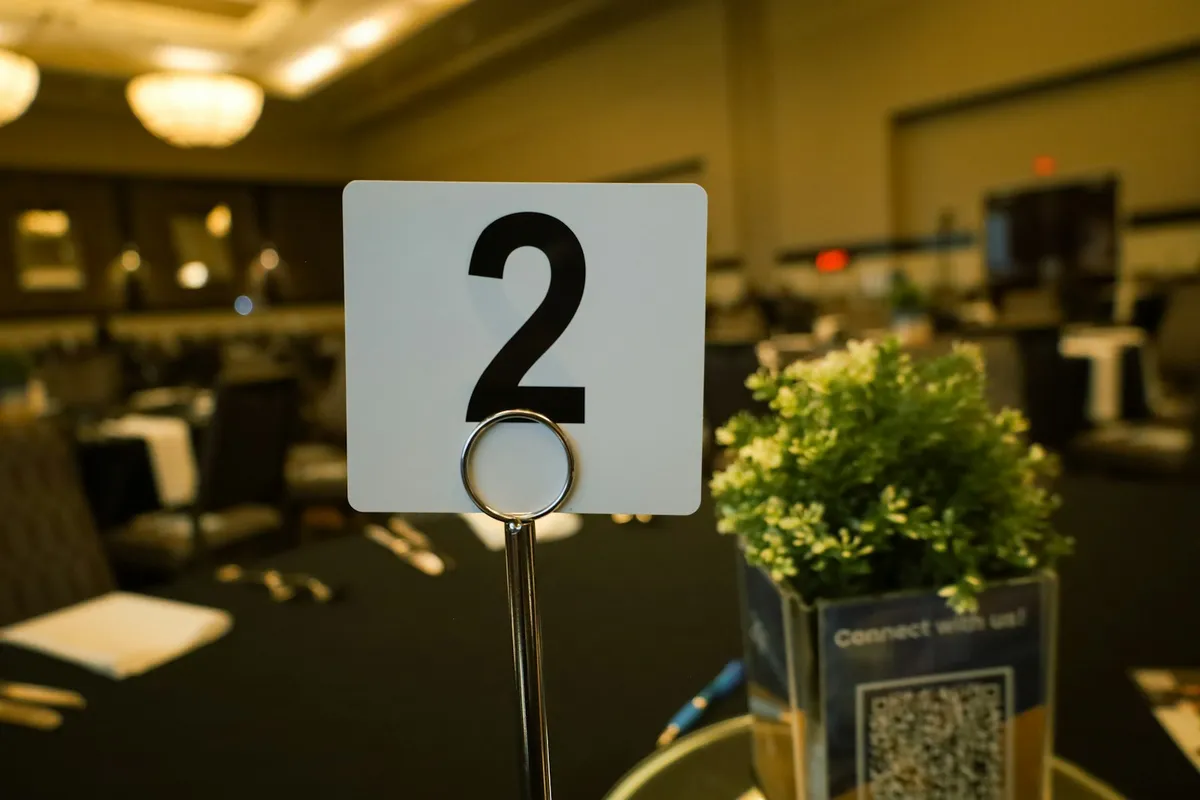 A numbered table card at a set banquet table